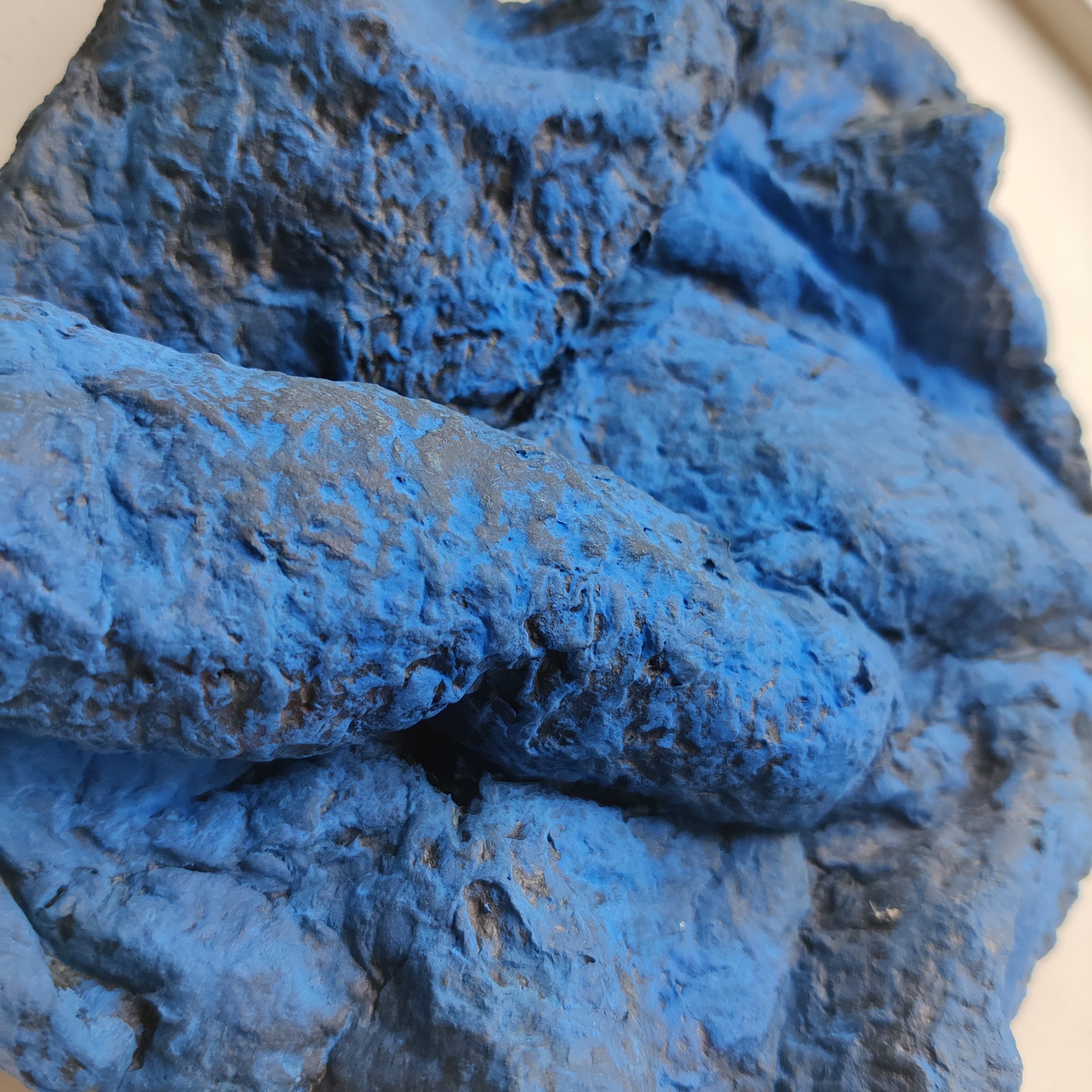 Close-up of blue textured material on a white background Volcano Part paper clay object